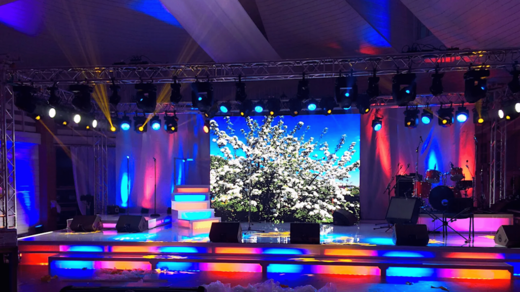 Vibrant stage setup with LED screens, dynamic lighting, and colorful stairs, ideal for concerts and performances